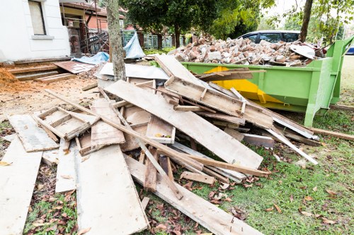 Company vehicle delivering a skip to a site